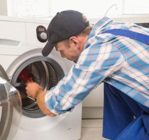 Washer mechanic repairing a broken appliance in Joondalup. We service all makes and models of washing machines including Miele, Samsung, Fisher and Pykel and much more